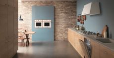 copper and white oven in blue wall in country kitchen