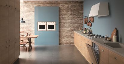 copper and white oven in blue wall in country kitchen
