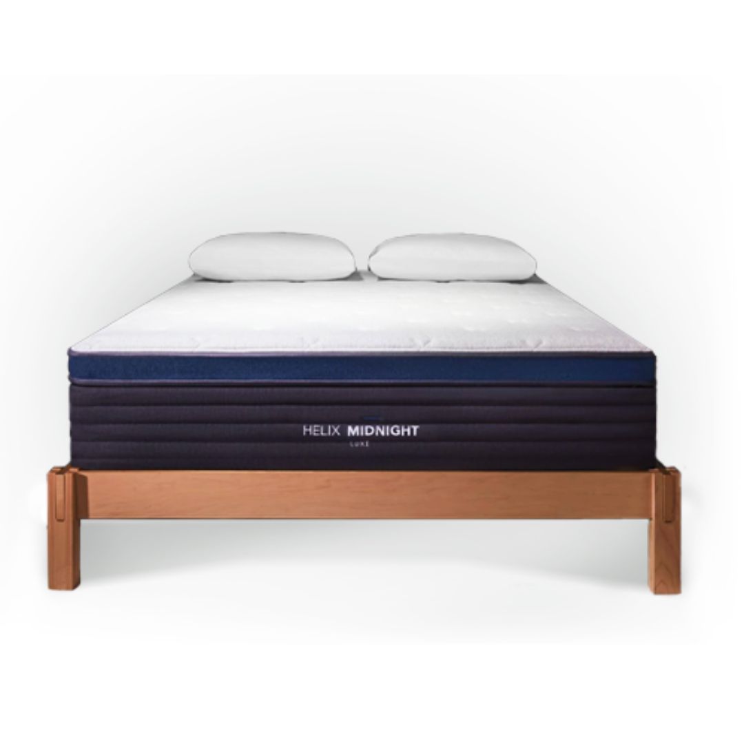 Helix Midnight Luxe mattress on a bed frame against a white background