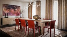 modern dining room with timber table, red dining chairs, patterned vintage rug, console with artwork hanging above, feature pendant light, and curtains over windows