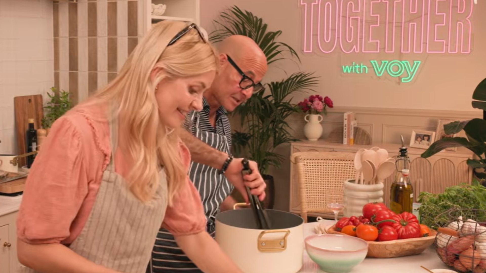 A still of Holly Willoughby and Stanley Tucci cooking together