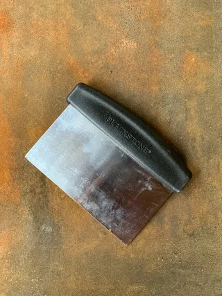 A blackstone griddle and scraper