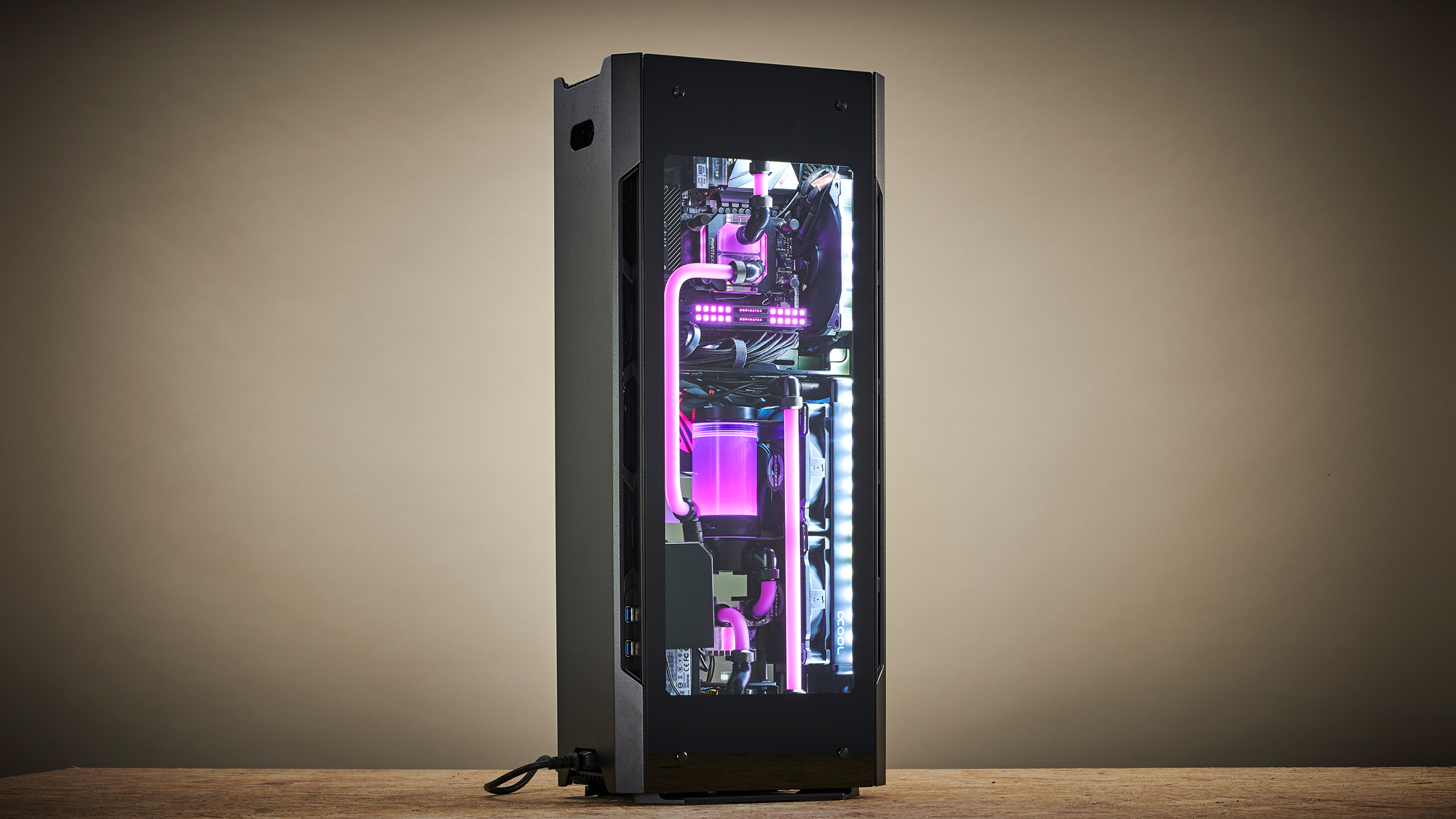 A custom desktop gaming PC with a liquid cooling loop featuring bright purple coolant..