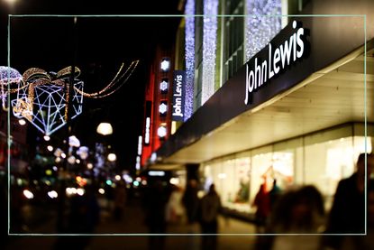 A photo of the front of a John Lewis shop with Christmas lights