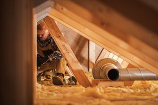 Tradesman insulating a house