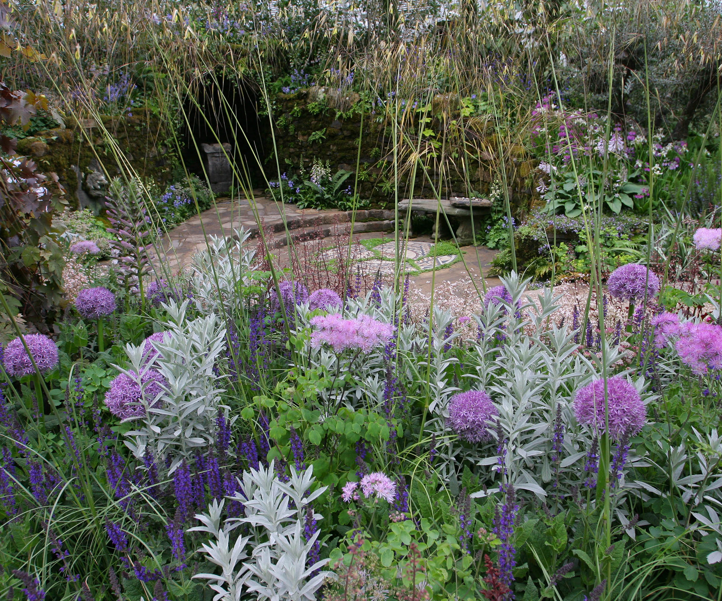 A sunken garden terrace surrounded by fragrant herbs and planting in a purple and silver colour scheme