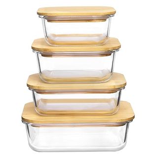 Four glass food storage containers with bamboo lids. 