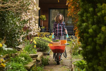 woman taking her tools down the garden