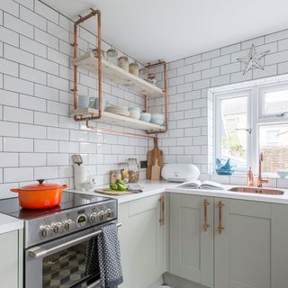 kitchen with white designed brick tiles on wall white windows and white cabinet with microwave