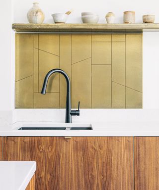 Modern kitchen with brass kitchen backsplash