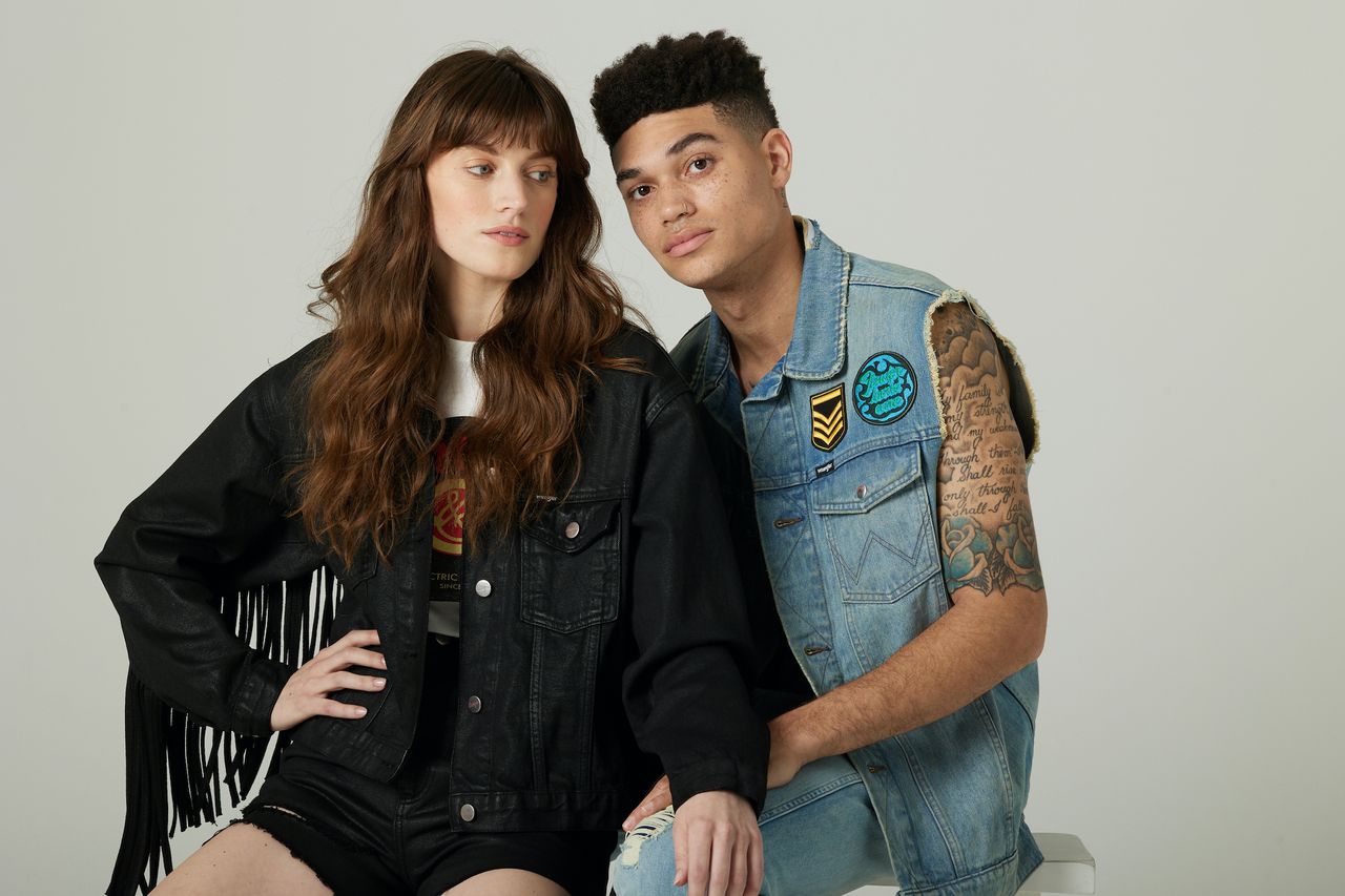 Two models model clothing items in the Fender x Wrangler collection