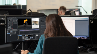 A woman studying at a computer at Vizrt University.