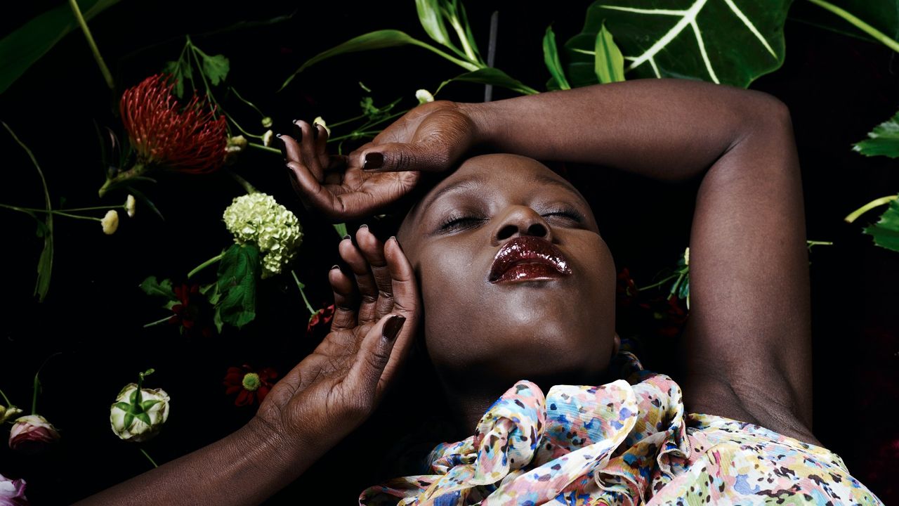 woman laying down among flowers