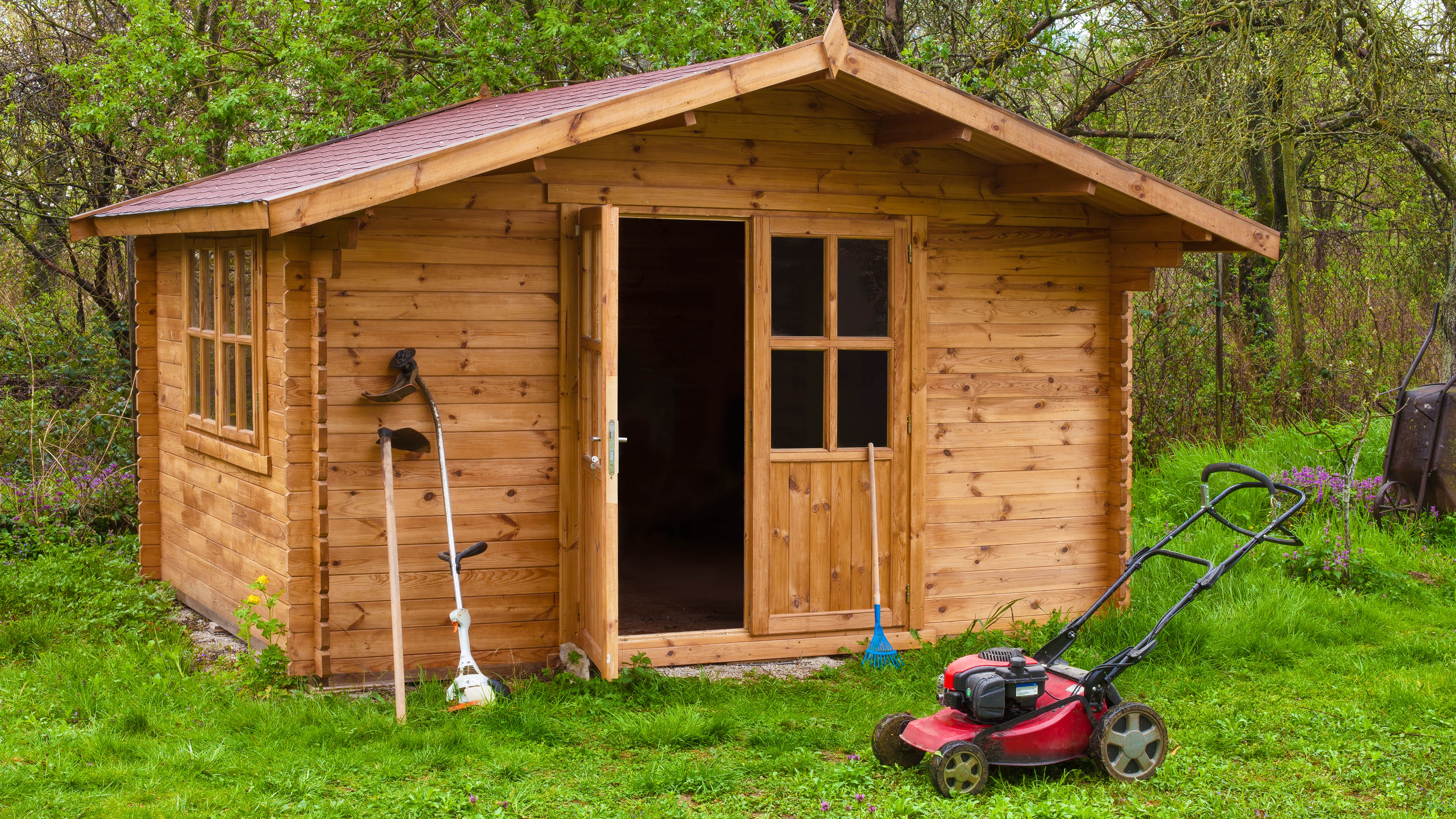 Shed with a lawn mower outside it
