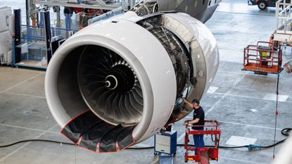 An employee of airplane manufacturer Elbe Flugzeugwerke GmbH works on an engine in Dresden, Germany.