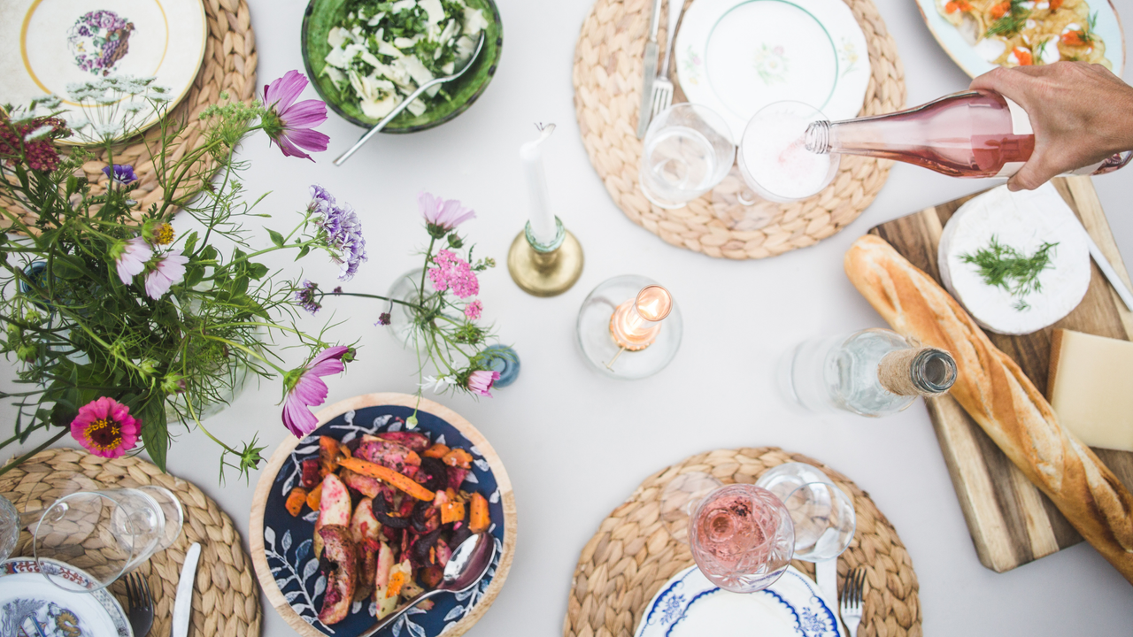 A beautifully decorated table, covered in a white tablecloth and blue-and-white crockery