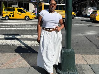 aniyah wears white tee and white linen dress with brown and white loafers