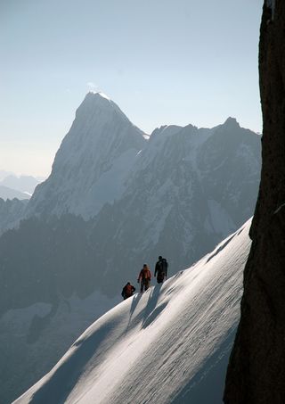 Three climbers with Mark Synnott on a mountaineering expedition.
