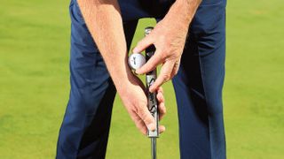 Golf Monthly Top 50 Coach places a golf ball on the putter to show how this drill can help consistency