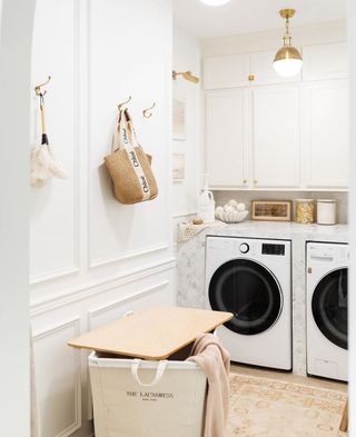 White laundry room with bag hanging on wall