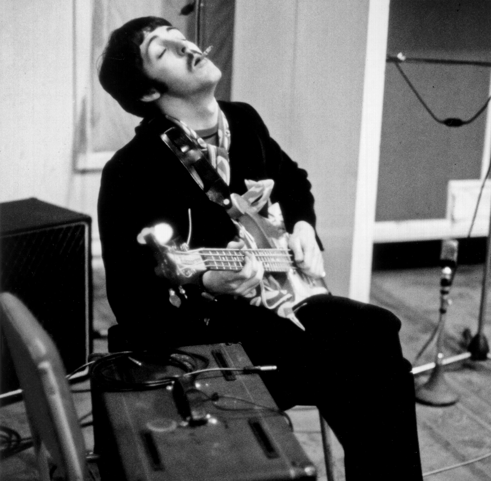 Paul McCartney of the rock and roll band "The Beatles" records bass in the studio in circa 1967.
