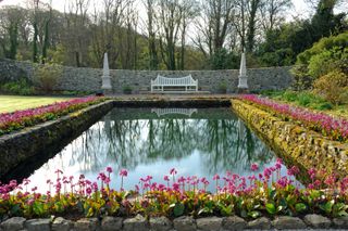 garden pond ideas: traditional pond with bench in english garden