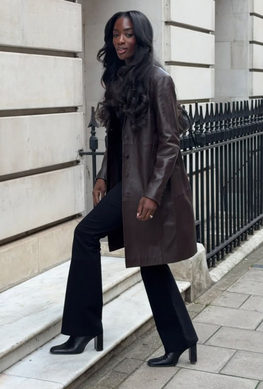 @_livmadeline wears a brown leather coat, black flared trousers and heeled boots