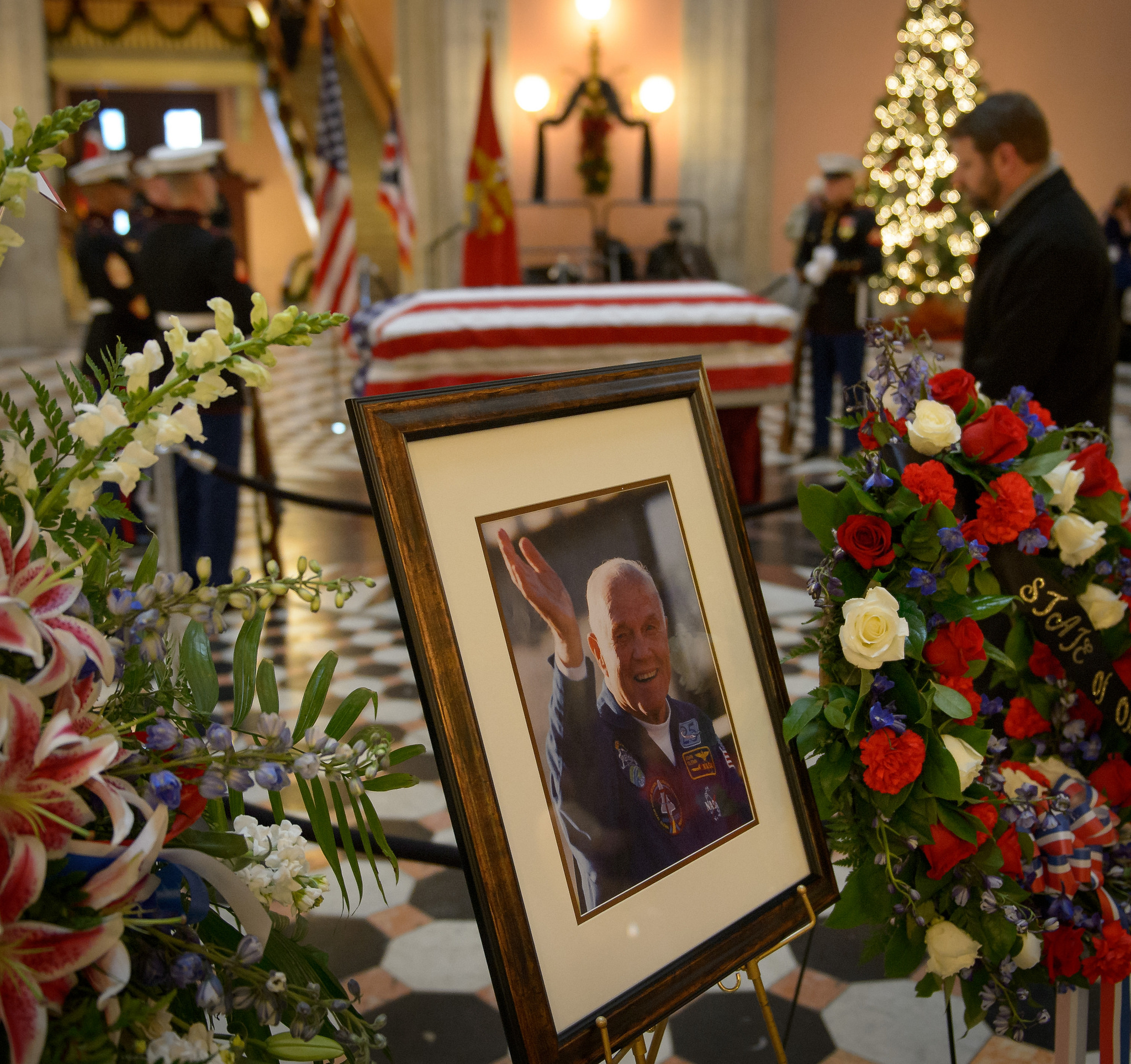 Members of the public pay their respects to former astronaut and U.S. Senator John Glenn as he lies in repose, under a United States Marine honor guard, in the Rotunda of the Ohio Statehouse in Columbus, Friday, Dec. 16, 2016. 