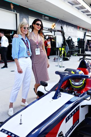 Kendall Jenner poses with Susie Wolff at the Miami Grand prix in a gingham tommy hilfiger dress