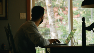 Man in home office on laptop