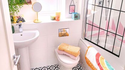 A bathroom with colorful towels and decorations