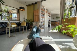 Our writer relaxes with her feet up in a calming space while trying the romanticise your life trend