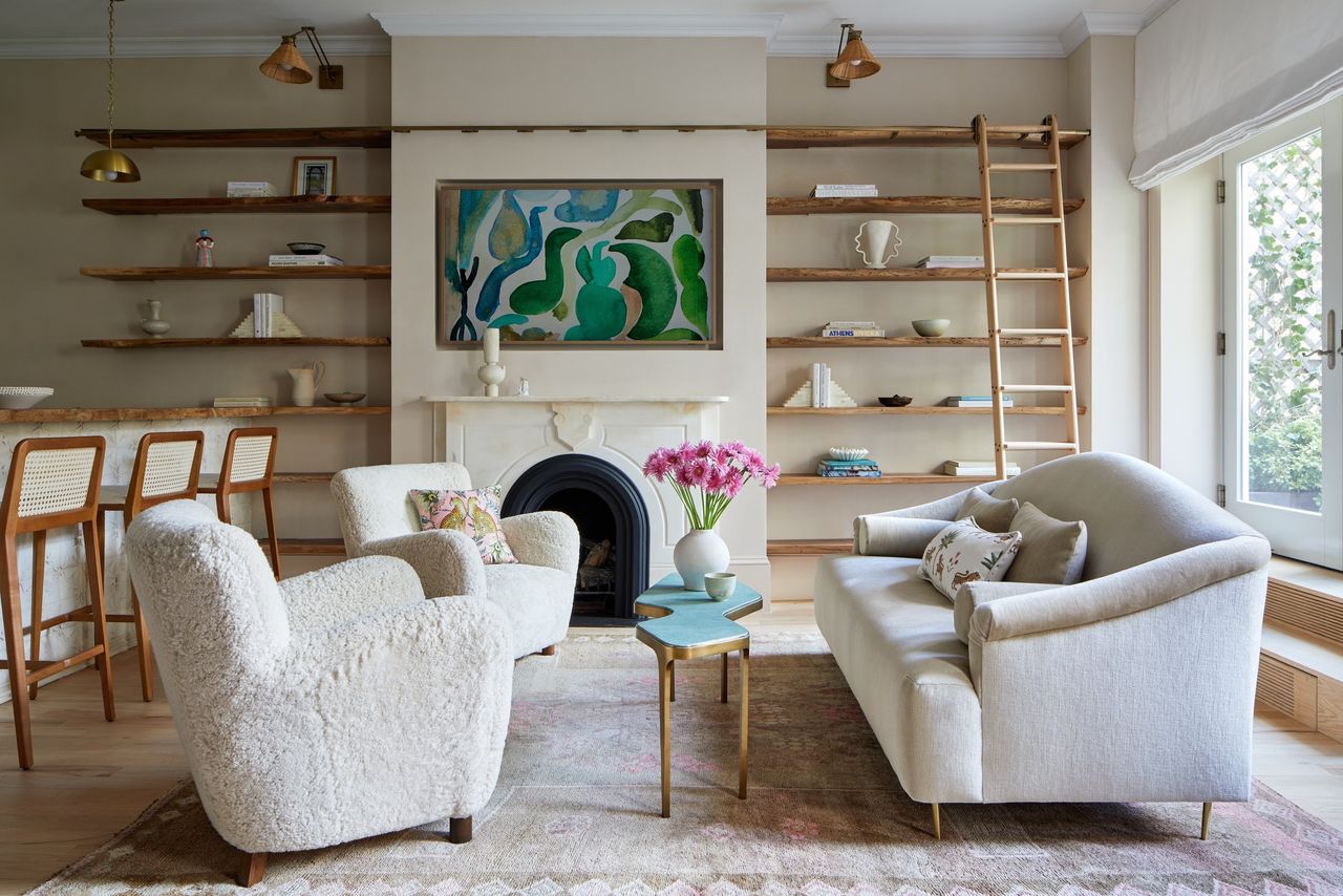 How to make a small house look expensive; small living room with boucle chairs and open shelving by DATE Interiors