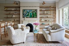 How to make a small house look expensive; small living room with boucle chairs and open shelving by DATE Interiors