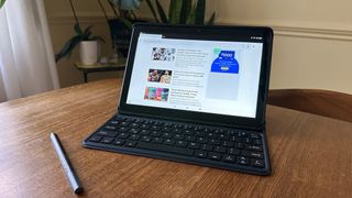 Amazon Fire HD 10 (2023) review unit on table with stylus and keyboard cover attached