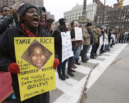 This Nov. 25, 2014, file photo, shows demonstrators blocking Public Square in Cleveland, during a protest over the police shooting of 12-year-old Tamir Rice.