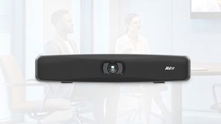 The new AVer VB150 videobar superimposed over a conference room.