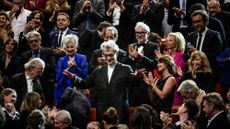 German film director Wim Wenders gestures during the 15th edition of the Lumiere Film Festival award ceremony as the crowd of attendees applauds in Lyon