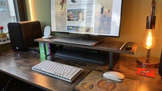 The Logitech MX Mechanical Mini for Mac on a wooden desk