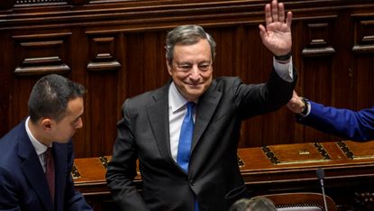 Italian Prime Minister Mario Draghi waves to lawmakers