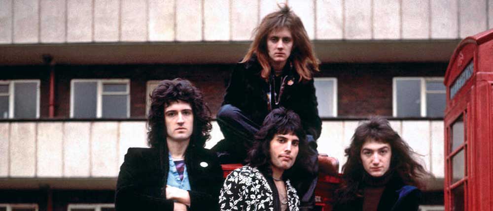 Queen posing outside a block of flats circa 1973