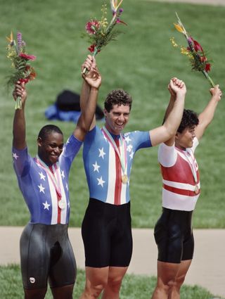 Mark Gorski of the United States celebrates winning gold with his silver medal placed compatriot Nelson Vails and bronze medallist Tsutomu Sakamoto of Japan in the Mens Sprint cycling event on 3rd August 1984 during the XXIII Olympic Summer Games at the Olympic Velodrome California State University at Dominguez Hills Carson California United States Photo by Steve PowellGetty Images