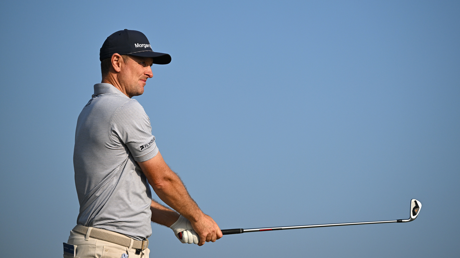 Justin Rose watches his iron shot into the green