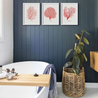 budget bathroom ideas, blue and white bathroom, trio of artwork on blue wall, white bath