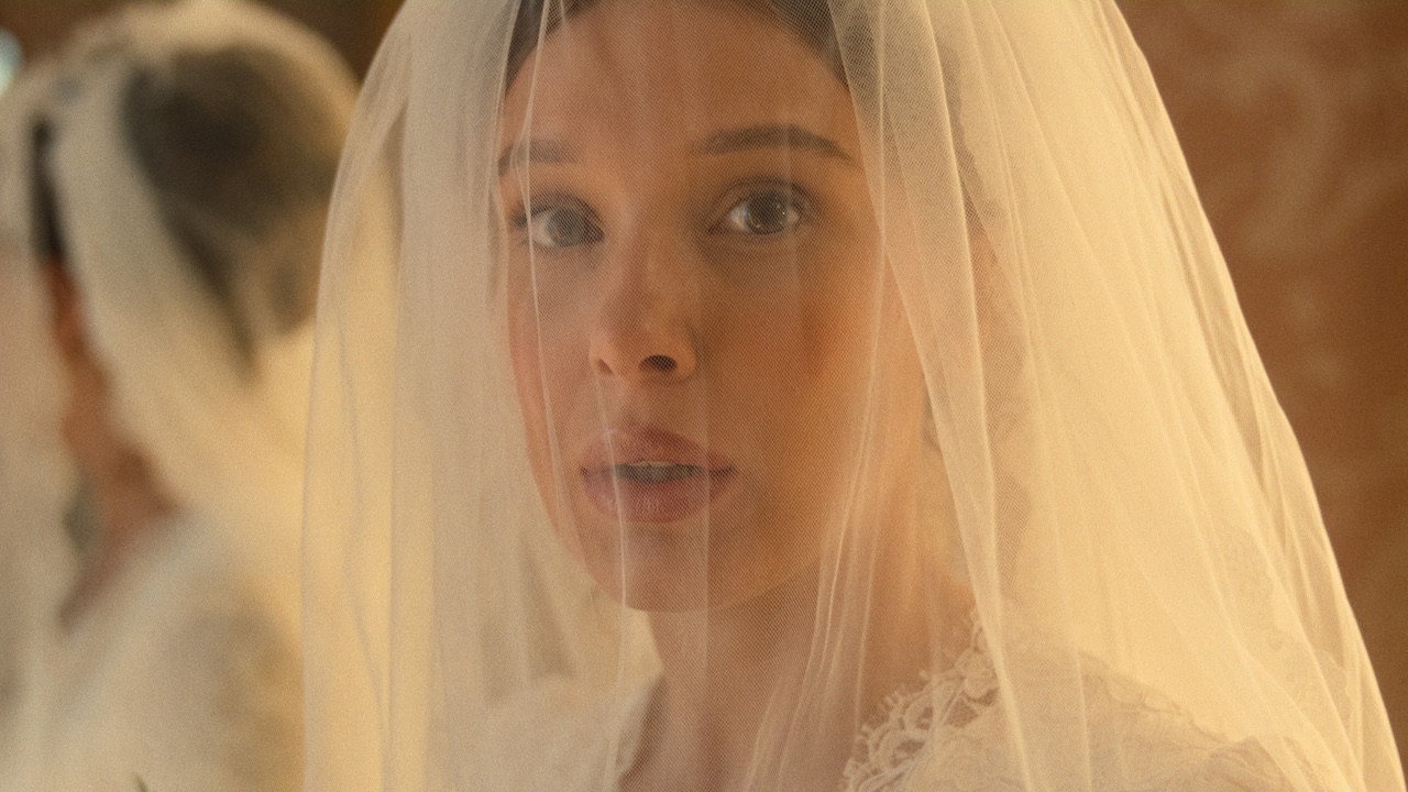 Enola looking worried wearing wedding veil in Enola Holmes 3