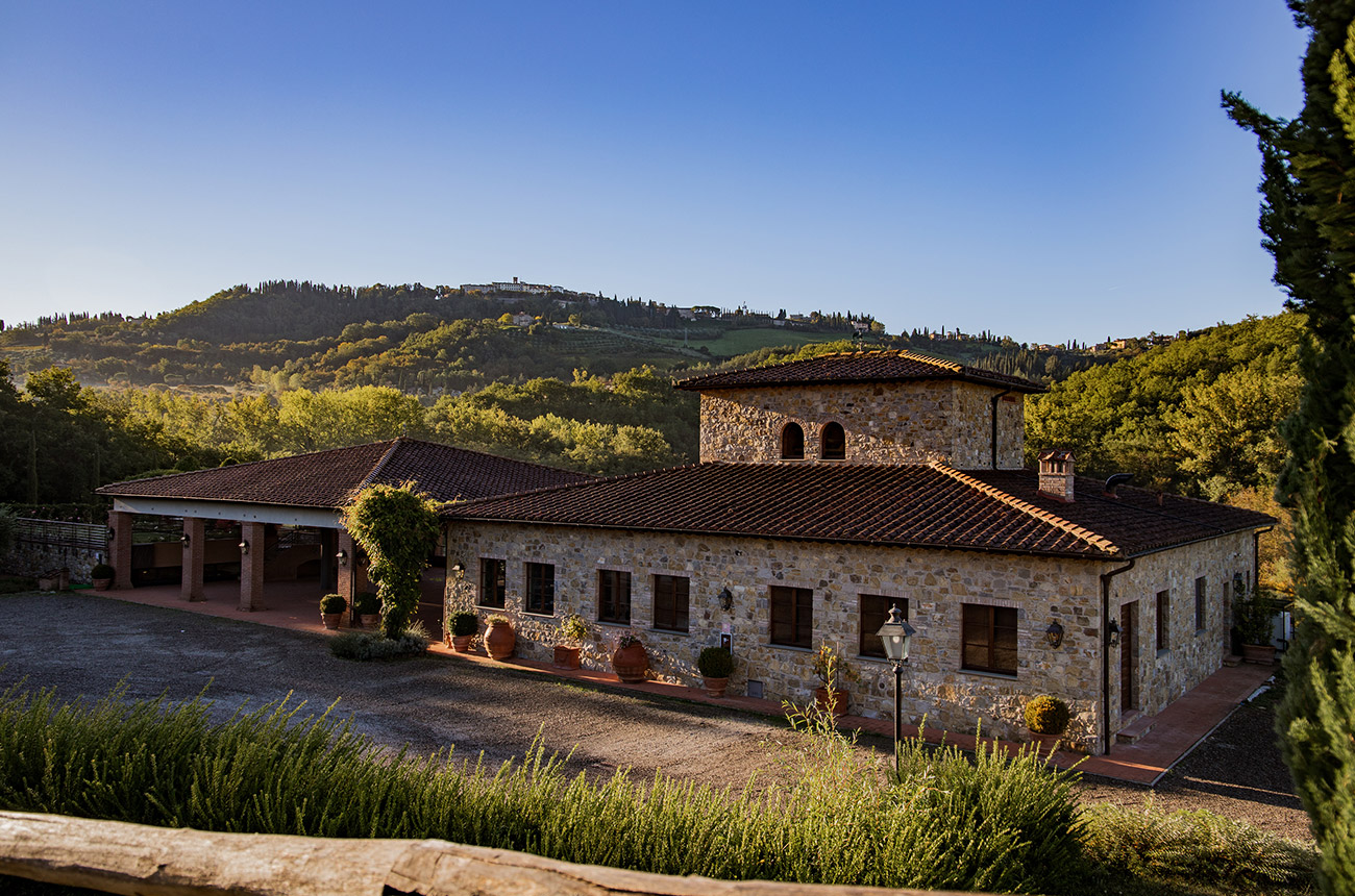 The Castello di Radda winery, with the village in the background, and a blue sky