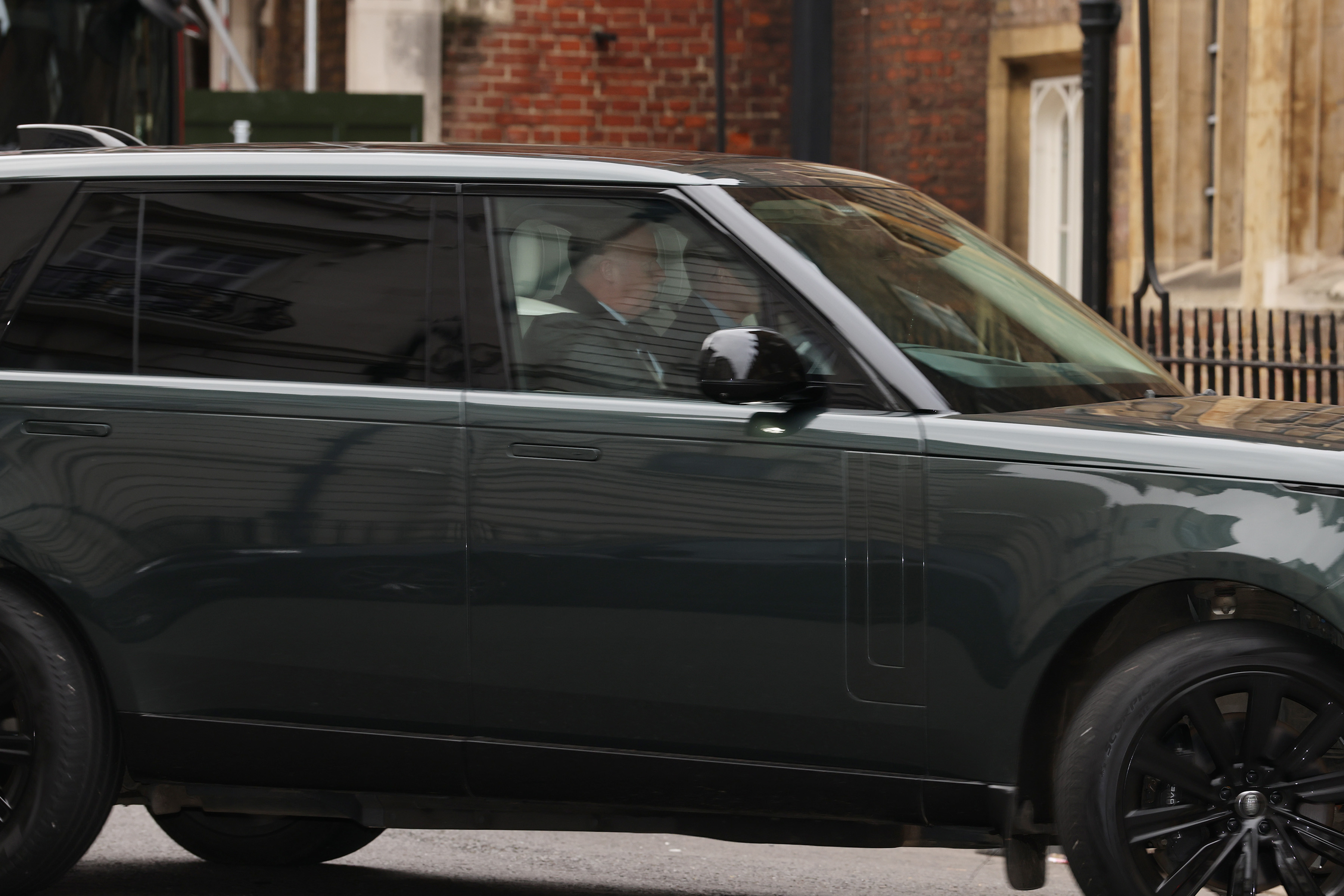 Prince Andrew riding in a range rover