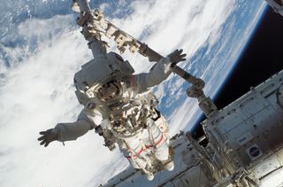 While conducting a spacewalk during shuttle mission STS-123 in 2008, NASA astronaut Rick Linnehan is anchored to the end of Canadarm2. Expedition 53 astronauts Mark Vande Hei and Joe Acaba will also "stand" on Canadarm2 during spacewalks on Oct. 10 and Oct. 18.