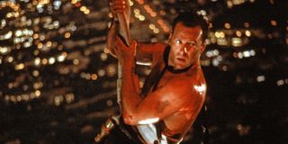 John McClane hanging by a fire hose in Die Hard