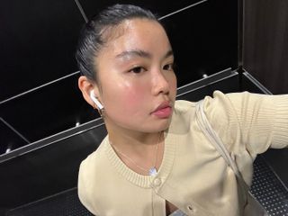 Allison Ho taking an elevator selfie with glowing skin